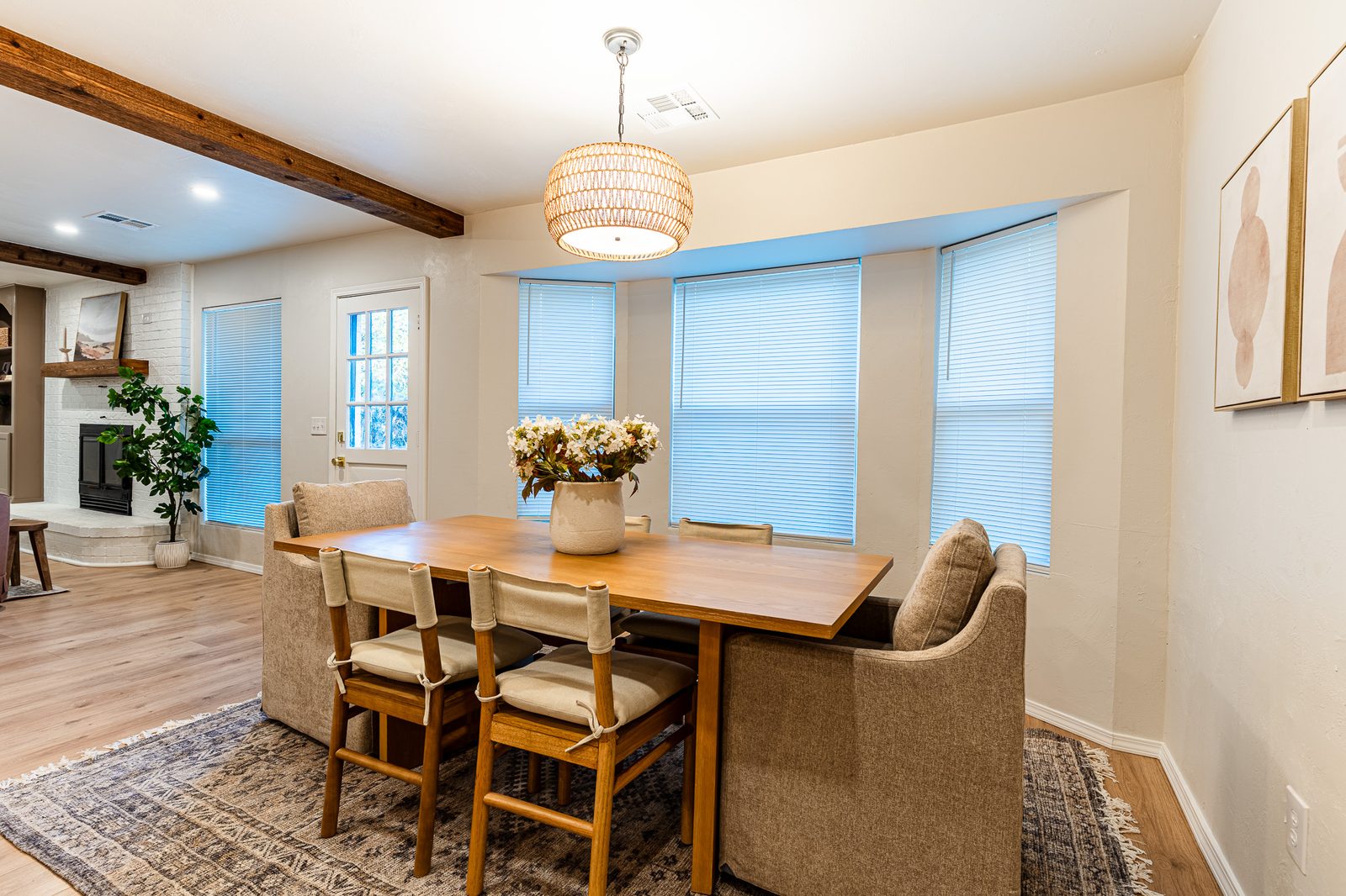 Dining area with bay windows, rattan pendant and wood table, listing photo in Edmond, OK